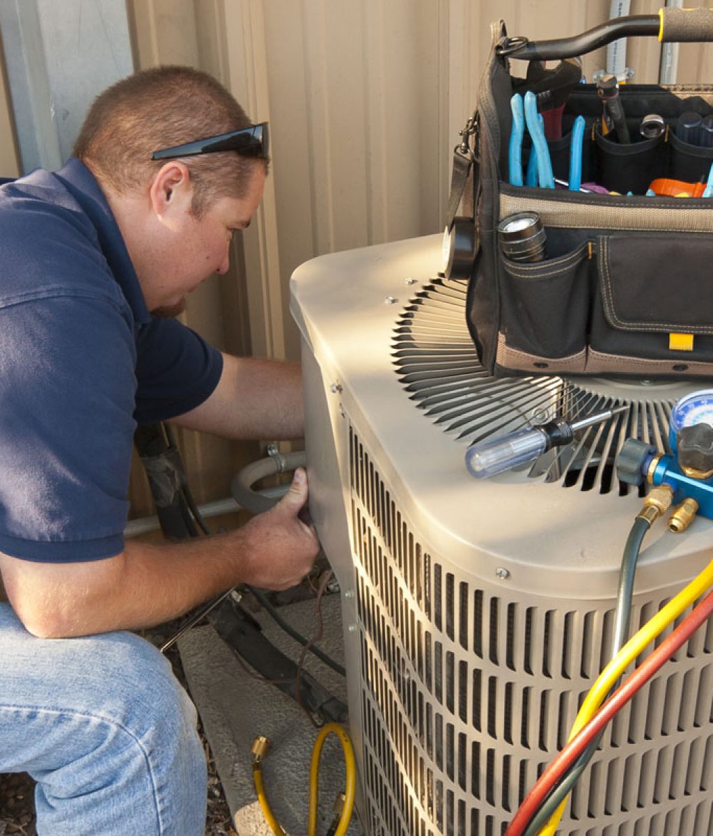 Air Fab Service Guy repairing Air Conditioning Unit with various tools
